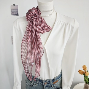 Elegant red plaid chiffon neck scarf with silver rose print styled on a mannequin
