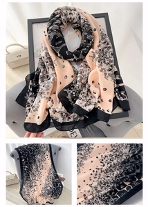 Detail shot of the lightweight linen leopard print scarf with black contrast borders