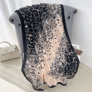 Large vintage leopard print sunshade shawl scarf draped over a sofa in a fashion setting