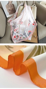 Detail showing the smooth silk texture and elegant floral patterns of the stylish scarf