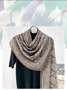 Detailed view of brown bohemian cotton scarf with white floral and paisley prints