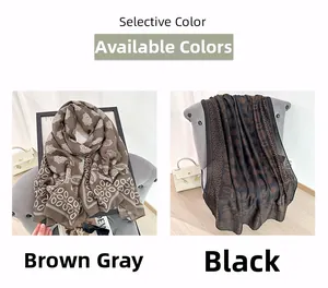 Detail showing printed scarves in brown-grey and black with retro geometric patterns
