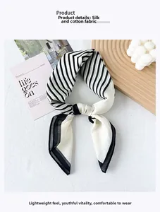 Detail shot of black and white striped silk-cotton scarf on a decorative background