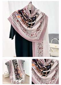 Detail of leopard print scarf with abstract geometric patterns and pink border design