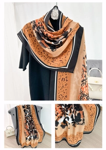 Detail of leopard print scarf with striped borders on a lightweight fabric for women