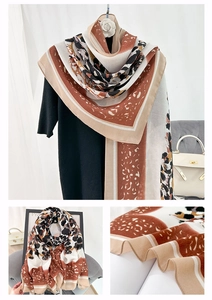 Detail of artistic leopard print scarf with geometric borders and soft fabric texture