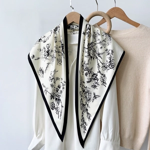 Elegant silk-like triangle scarf with black paisley and floral prints on ivory background
