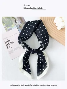 Détail d'un foulard en soie et coton à pois avec motifs floraux sur un plateau en bois