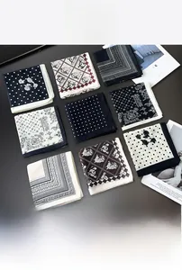 Flat lay of silk-cotton square scarves with diverse vintage paisley and polka dot patterns
