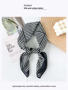 Macro shot of black and white striped silk cotton scarf with elegant texture details