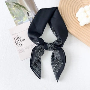 Modern black silk blend paisley square scarf with white dots on a marble background