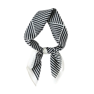 Classic black and white striped silk scarf tied in a bow for elegant women outfits