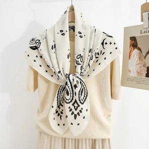Detail of bohemian paisley scarf with monochrome print styled on a knit sweater