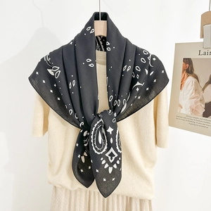 Detail of vintage paisley silk scarf with white floral pattern on black background