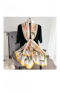 Detail of silk long scarf with yellow and orange floral patterns in French style