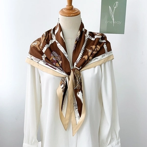 Detail of silk scarf with retro horse patterns draped on a white shirt