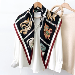 Elegant silk scarf with classical abstract pattern on a white shirt and wooden hanger