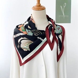 Detail of nautical print silk scarf tied on a mannequin with a classic red border