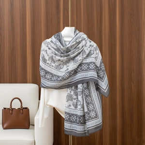 Close-up of elegant grey and white scarf with vintage patterns on a white mannequin stand