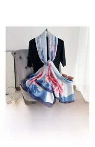 Detail of silk satin scarf featuring elegant pink lotus floral prints on blue border