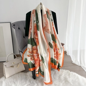 Elegant silk-style shawl with orange floral prints and bright border for summer style