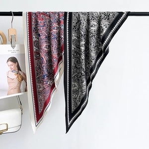 French Hepburn style paisley and botanical print square silk scarves on a hanger