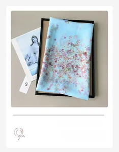 Detail of light blue floral chiffon scarf with soft semi-transparent texture and flower print