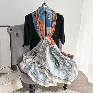 Elegant silk scarf with paisley print and vibrant orange and blue patterns for women