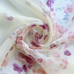 Close-up of translucent light blue floral chiffon fabric showing texture and soft drape