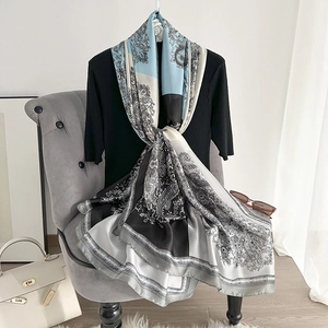 Elegant paisley print silk shawl in blue and grey styled over a black knit top