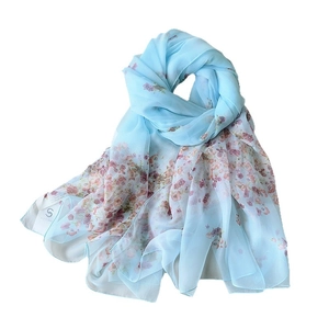 Elegant light blue floral scarf made of thin, sheer fabric for summer sun protection