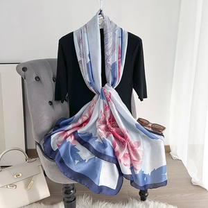 Elegant silk-style long scarf with floral print and blue trim for summer sun protection