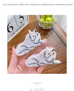 Wolf shape acetic acid hair claw clip in white marble finish being held by hand
