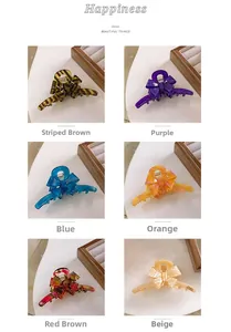 Detail view of acetate bow hair claws in six colors including tortoiseshell and marble