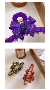 Detailed view of acetate hair claws featuring purple bow and tortoiseshell patterns