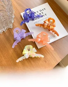 Collection of large acetate bow hair claws in diverse marble patterns and colors