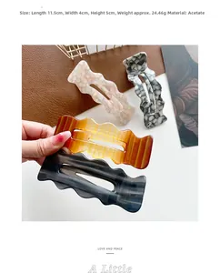 Macro view showing 11.5cm acetate hair clip dimensions with wavy hollowed-out texture