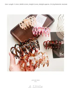 Detail view of 11.4cm large acetate hair claw clips with marble and tortoiseshell patterns