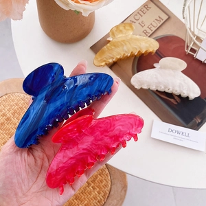 Elegant marble acetate hair claws in blue, pink, and white for versatile styling