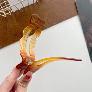 Large tortoiseshell acetate hair claw clip with wavy edges for thick hair styling
