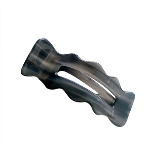 Modern wavy grey acetate hair clip with cutout design and marble texture pattern