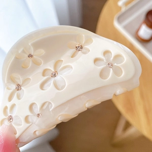 Creamy white acetate flower hair claw clip with champagne rhinestones and cutout design