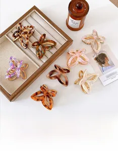 Collection of butterfly hair claws in acetate finishes like marble and tortoiseshell patterns