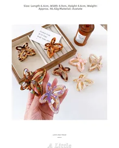 Detail showing dimensions 6.6cm by 4.9cm of acetate butterfly hair claw in warm setting