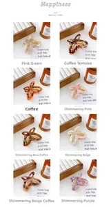 Detail view of eight colorful butterfly hair claws in acetate and gold metal finishes