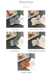 Detailed view of acetate koala hair claws in grey and marble white colors