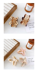 Detail of hollow butterfly metal hair claws in tortoise shell and pink marble finishes