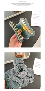 Detail of cellulose acetate hair claw clips with marble texture and golden springs