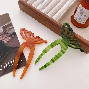 Elegant butterfly acetate hair pins in amber and green with marble texture finish