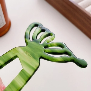 Green marble acetate butterfly hair stick with handmade gold logo and u-shaped design